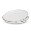 A white plate with gold rim AI-generated content may be incorrect.